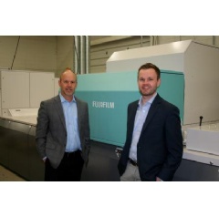 Todd Meissner, left, president, Color Ink, proudly stands next to the J Press 720S, along with his son, Austin, Sales and Sourcing Manager, at their Sussex, Wisc. facility. 
