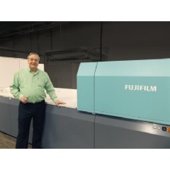 Raymond Ballew, VP of Administration, Floor Productions, proudly stands next to Fujifilms J Press 720S, at their Dalton, Georgia facility.
