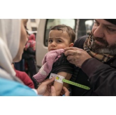 UNICEF/UN0781278/Al-Asadi
On 10 February 2023, Sondos, two years and eight months, in her fathers arms, is screened for malnutrition by a UNICEF-supported mobile health team worker, (see complete caption below)