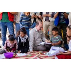 UNICEF/Choufany
UNICEF Deputy Executive Director Ted Chaiban with children during a visit to the Saadnayel Makani community center that offers an integrated package of services for children, adolescents, and caregivers. 13 October 2024.