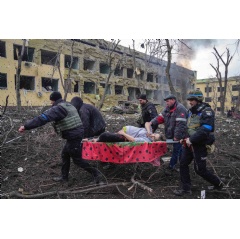 Ukrainian emergency workers carry an injured pregnant woman outside of a bombed maternity hospital in Mariupol, Ukraine. (AP Photo/Evgeniy Maloletka)
