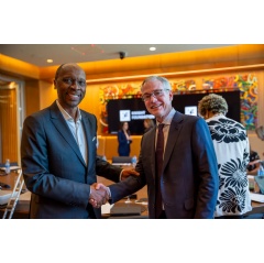 Outgoing Board Chair Frank Borges shakes hands with new Board Chair Chris Austen at the conclusion of the March 2024 meeting of trustees in Miami.