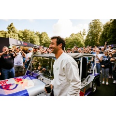 Pictured: Daniel Ricciardo hopping out of a Red Bull MOKE