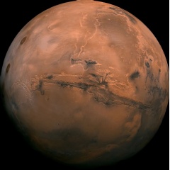 Mosaic of the Valles Marineris hemisphere of Mars projected into point perspective, a view similar to that which one would see from a spacecraft. The distance is 2500 kilometers from the surface of the planet, with the scale being .6km/pixel.
NASA