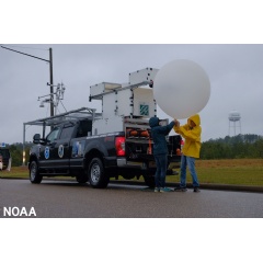 Researchers prepare to launch an experimental weather balloon on April 5, 2022, near a storm in Greenville, Alabama. (NOAA)