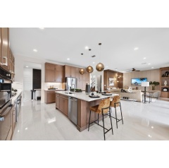 Luxuriously designed open-plan kitchen and living area in a GL Homes RiverCreek Cascade model home, embodying the award-winning designs that earned the 2024 Superior Home Awards from Lee County Builder Industry Associations Parade of Homes.